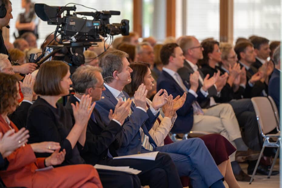 Publikum applaudiert, dazwischen auch eine große Kamer von einem Filmteam.
